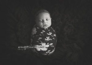 newborn girl in black floral wrap