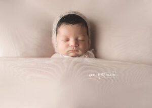 newborn girl under white blanket