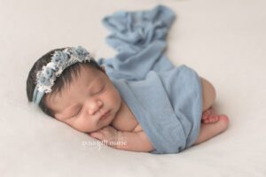 newborn girl photography session - baby wrapped in blue
