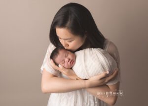 artfully photograph your newborn - mom kissing baby girl