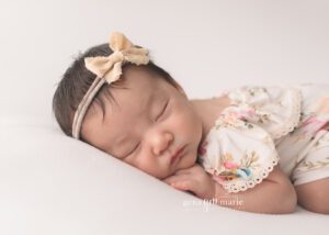 newborn girl photographed in floral romper