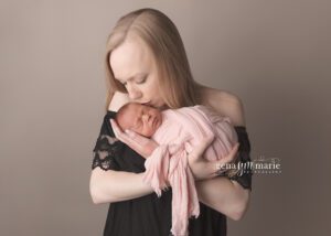 newborn babies kissed by mom