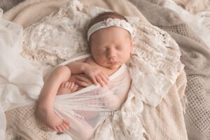 newborn babies on cream layers